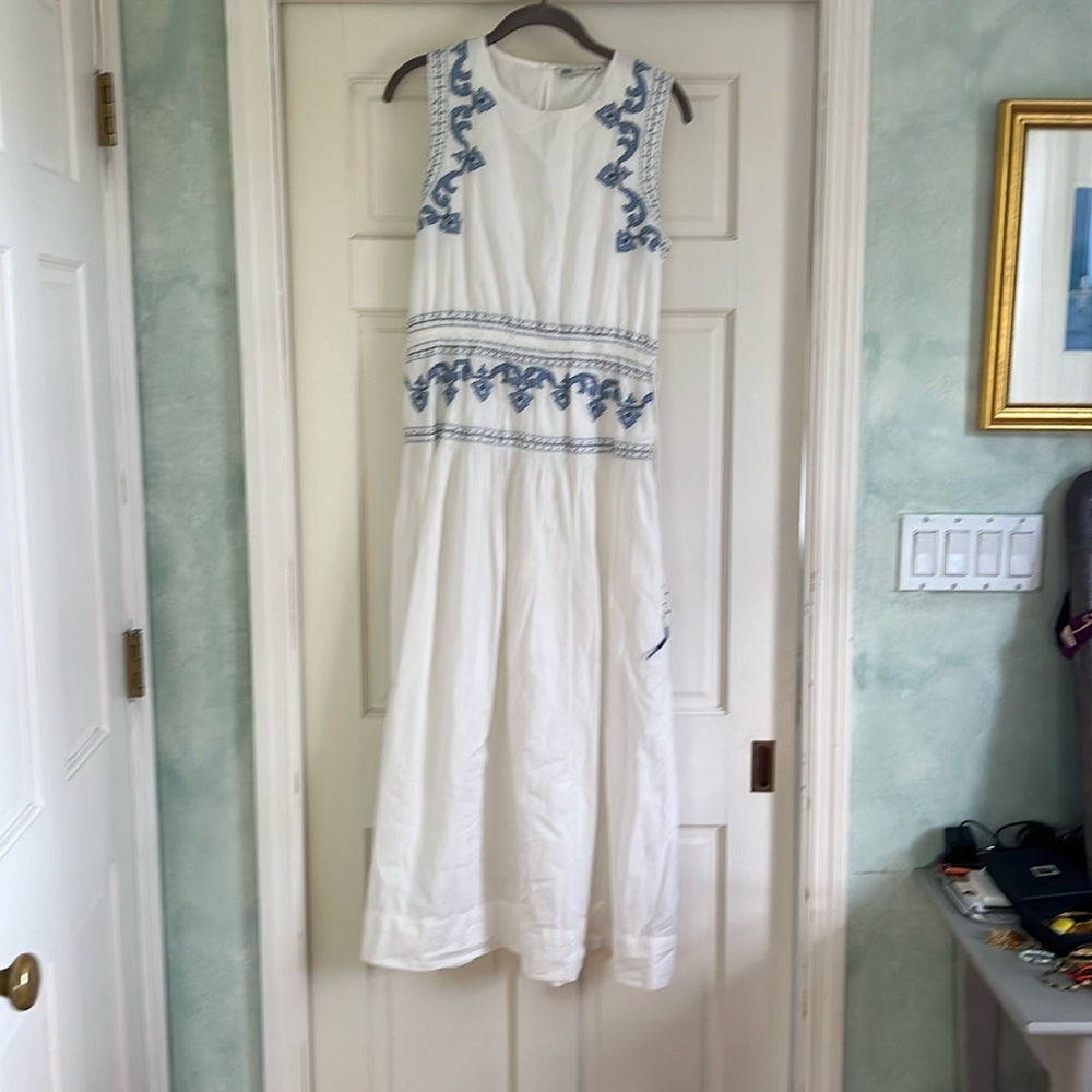 White maxi dress with blue embroidery.